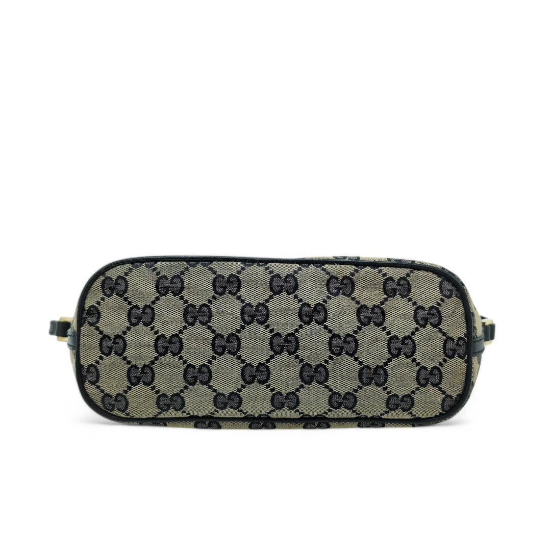 Gucci Handtasche Baguette mit schwarzen Lederdetails monogram beige